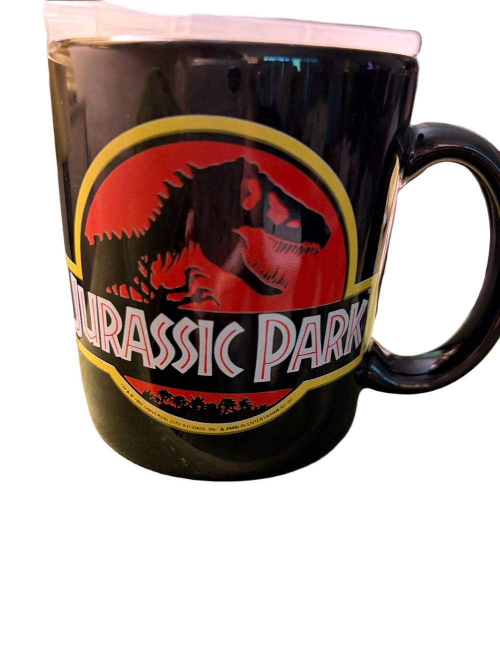 1992 Dankin Official Jurassic park black coffee mug featuring classic Trex logo